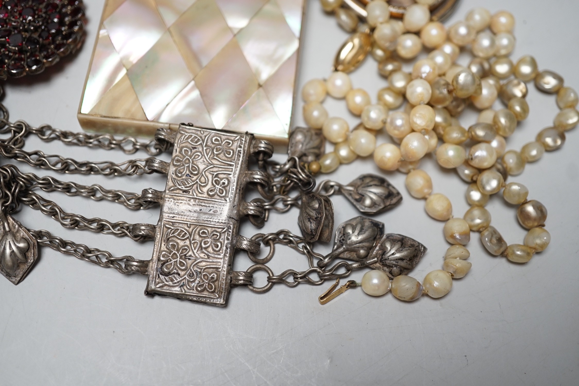 A collection of Victorian and later costume jewellery and a mother of pearl card case.